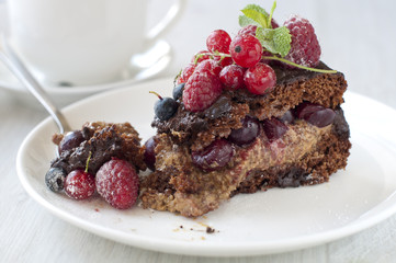 Fototapeta na wymiar Chocolate cake with strawberry and raspberry and cherries