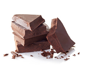 Heap of broken chocolate pieces on white background