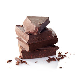 Heap of broken chocolate pieces on white background