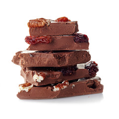 Heap of broken chocolate pieces on white background