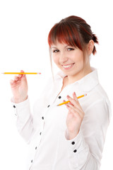 young woman playing with two pencils