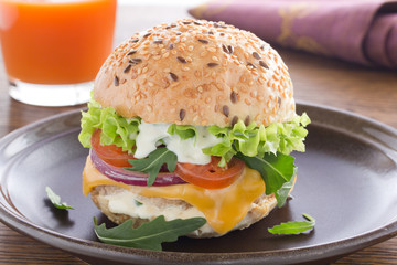 Burger with meat and vegetables.