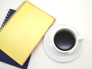 notebooks and a cup of coffee on white background