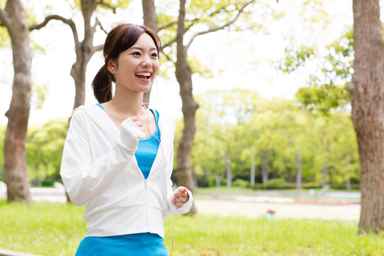 young asian woman jogging in the park
