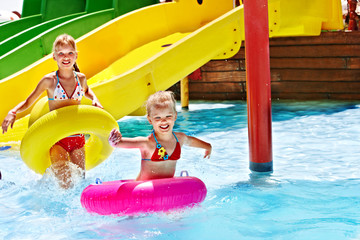 Child on water slide at aquapark.