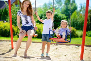 Fototapeta na wymiar Happy family on playground