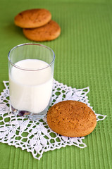 Glass of milk and oat cookies.