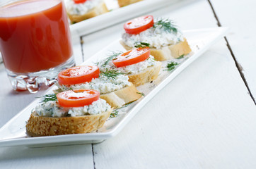 Breakfast of cottage cheese bruschettas and tomato juice