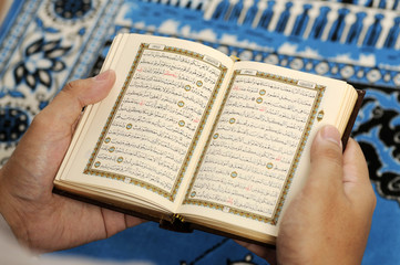 Young Man Reading The Holy Koran - obrazy, fototapety, plakaty