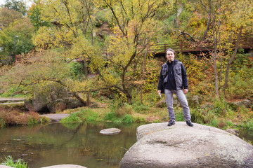 Man in autumn forest with river