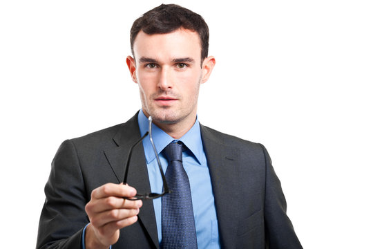 Young businessman holding glasses