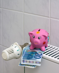 Piggy bank with radiator thermostat saving heating costs