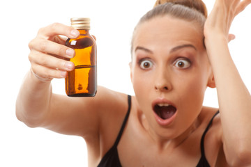 Fototapeta premium woman holding a bottle of medicine, isolated on white background