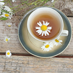 chamomile tea on wooden background