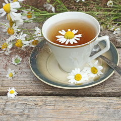 chamomile tea on wooden background