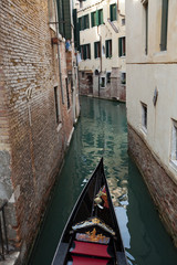 Obraz na płótnie Canvas Narrow canal with gondolas in Venice, Italy