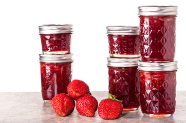 Fresh strawberries preserved in jars