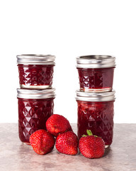 Fresh strawberries preserved in jars