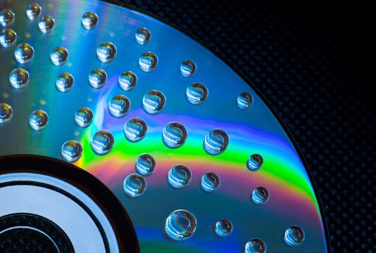 Abstract music background, water drops on CD/DVD