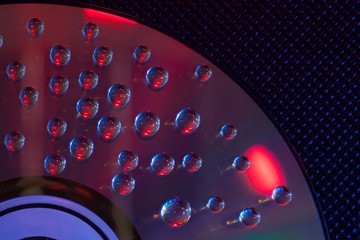 Abstract music background, water drops on CD/DVD