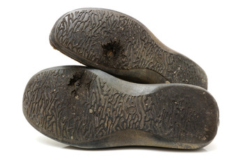 concept of poor people with old used shoes with  hole isolated