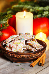 Vintage wooden bowl of gingerbread cookies on christmas eve tabl