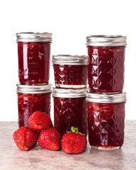 Fresh strawberries preserved in jars