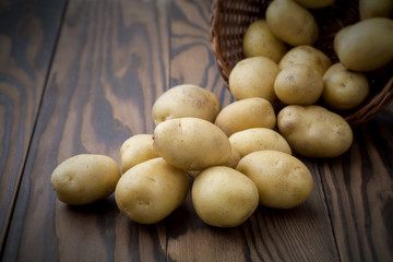 Fresh potatoes on a wooden background