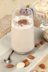 Glass of chocolate-cream cocktail on wooden table close-up