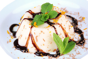 Panna Cotta with chocolate sauce, isolated on white