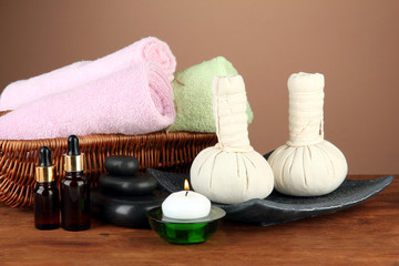 Fototapeta na wymiar Textile massage spa equipment on a brown background