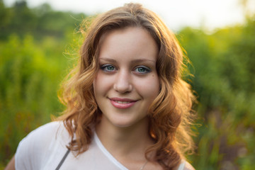 Outdoor portrait of young pretty women with ginger hair