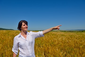 young woman in wheat field at summer