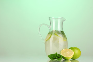 Lemonade in pitcher on turquoise background