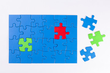 Jigsaw puzzle with colored pieces signifying diversity and equal
