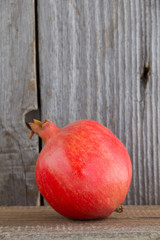 Juicy pomegranate and its half with leaves.