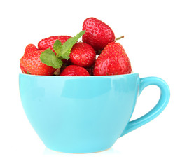Ripe sweet strawberries in blue cup, isolated on white