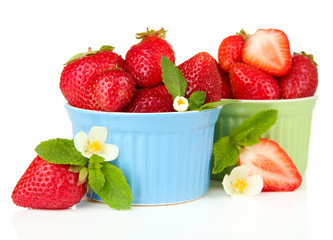 Ripe sweet strawberries in bowls, isolated on white