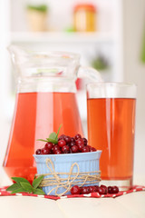 Pitcher and glass of cranberry juice with red cranberries