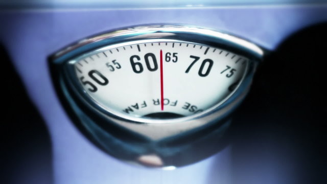 man weighting on scale