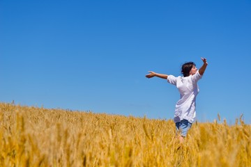 Fototapeta premium young woman in wheat field at summer