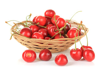 Cherry berries in wicker basket isolated on white