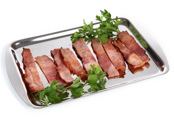 Fried bacon on metal tray isolated on white
