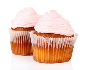 Tasty muffins with cream isolated on white