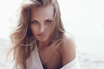 Fototapeta premium Portrait of a beautiful woman, the wind fluttering hair