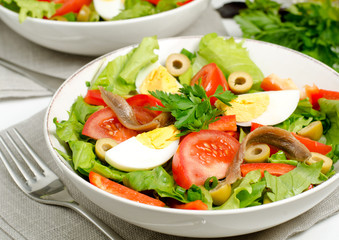 Salad with tomatoes, olives, eggs and anchovies