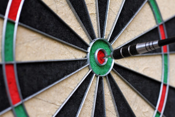 dartboard with dart in the center