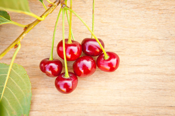 Ripe cherries on a wooden background