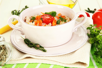 Delicious rice with vegetables and herbs in pot