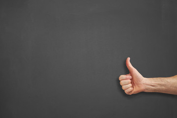 Hands in front of chalkboard